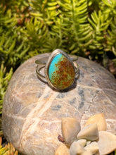 Load image into Gallery viewer, Turquoise stone ring on a rock with green foliage